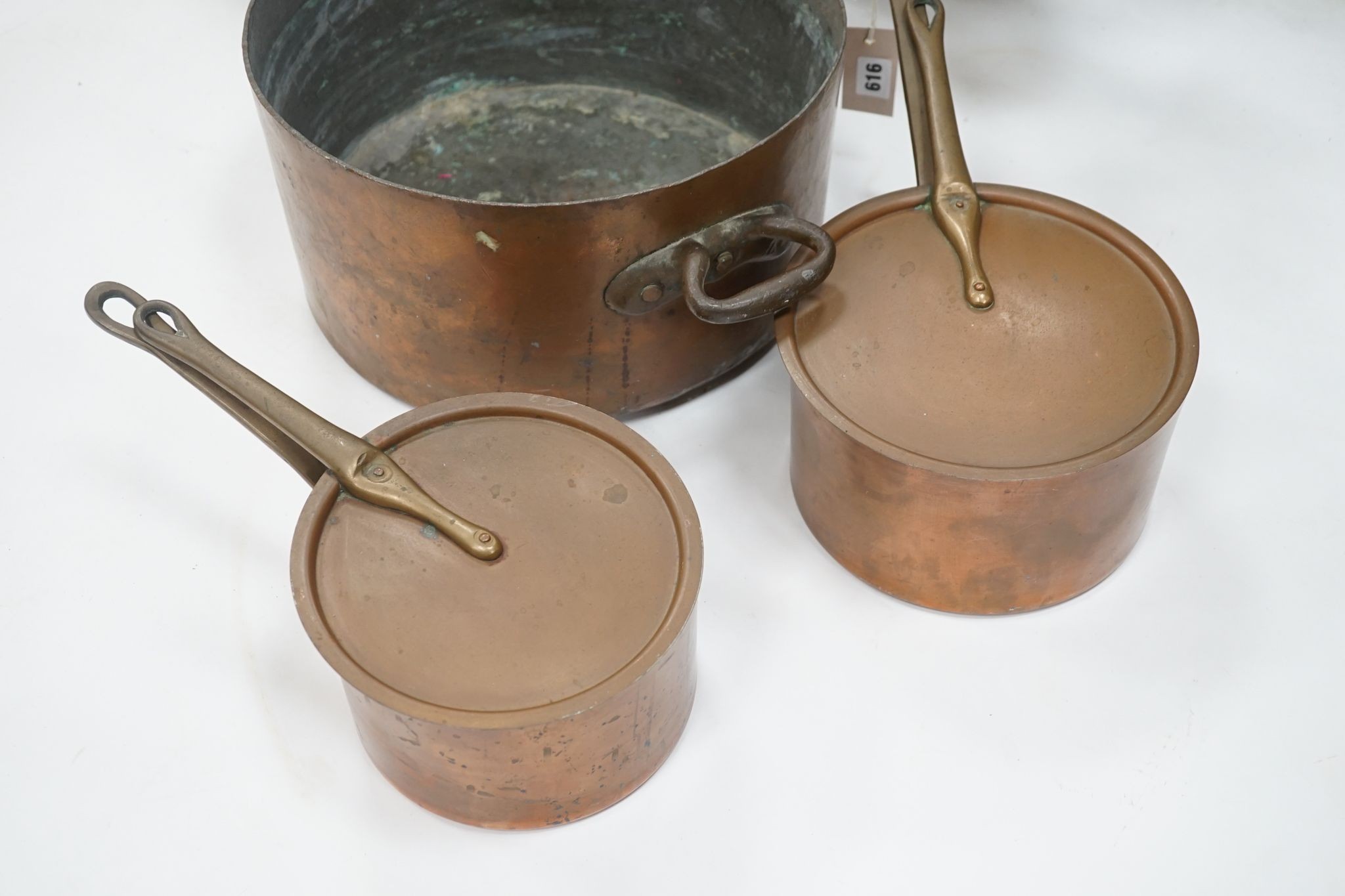 A group of three Jaeggi & Sons copper saucepans